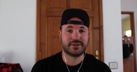 Young man doing video call while wearing earphones Stock Footage 149116456