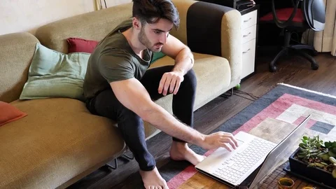 Young man doing videochat at home on laptop PC Stock Footage 78480537