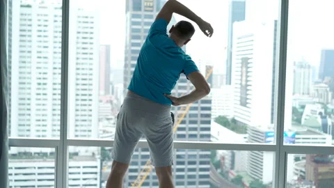 Young man doing warm-up before training at home, 4K Video stock 99845086