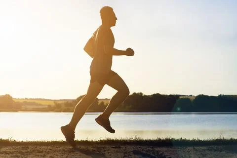 Young man doing workout, exercising and running. Stock Photos