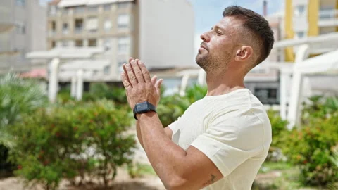 Young man doing yoga exercise at park Stock Footage 247379064