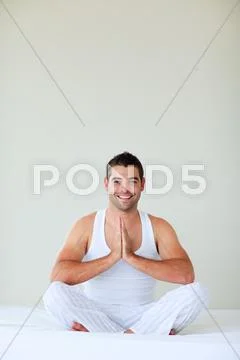 Young man doing yoga in his bedroom Stock Photos