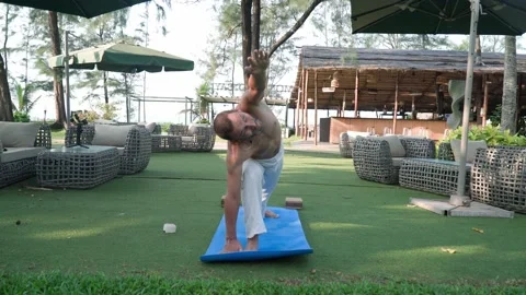 Young man doing yoga on vacation in a resort in India 스톡 동영상 168493355