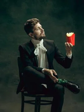 Young man as Dorian Gray on dark background. Retro style, comparison of eras Stock Photos
