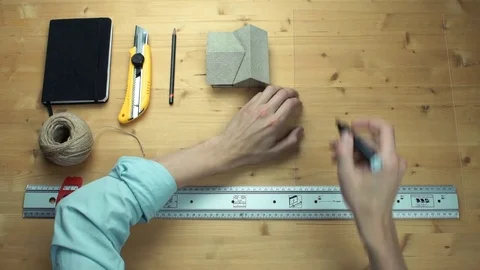 Young man drawing house at plastic glass with black marker at desk. Video stock 82901584