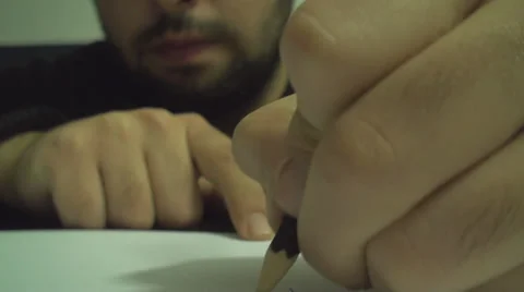 Young Man Drawing On Paper With A Pencil Front Shot Stock Footage 33762877
