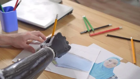 Young man draws a bionic prosthetic arm top view Stock Footage 119384627