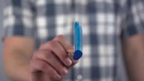 A young man draws a mathematical plus sign on the glass. A man in a shirt draws Stock Footage 235733956