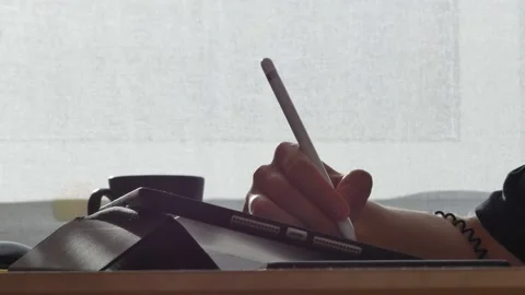 A young man draws with a pen on a tablet pc Stock Footage 220337263