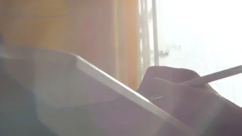 A young man draws with a pen on a tablet pc Stock Footage 220337317