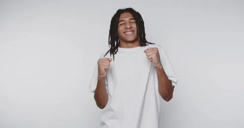A young man with dreadlocks celebrating with a joyful expression. Stock Footage 315161205