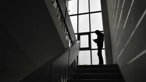  young man dressed in dark clothes with a hood on his head stands on the landing Stock Footage 219632027