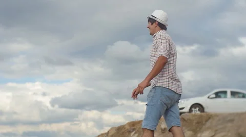 A young man, dressed for summer, something specifies a hand Stock-Footage 60843852