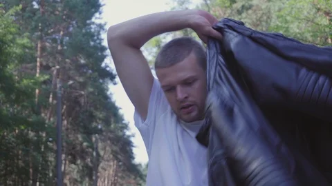 A young man dresses a jacket Video stock 94348234