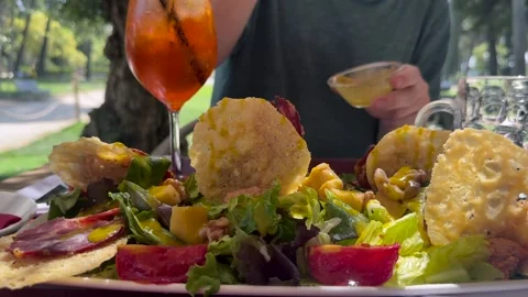 Young Man Dressing in Slow Motion a Colorful Mediterranean Salad with Mango Stock Footage 336630103