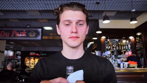 Young man drink alcohol in cafe Stock Footage 89222890