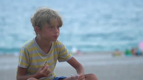 Young man Drink tea at the beach Stock Footage 80379105