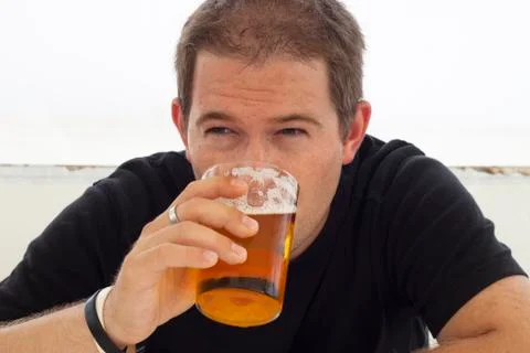 Young man drinking beer Stock Photos