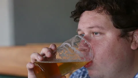 Young man drinking a beer in pub or bar Stock Footage 95619163