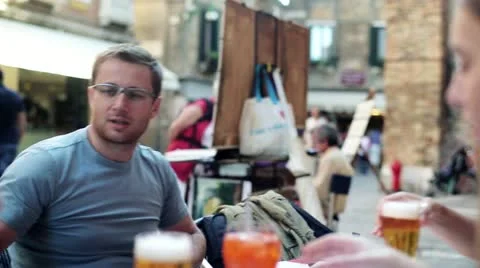 Young man drinking beer in the restaurant, outdoors Stock Footage 12317787
