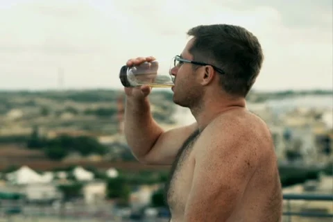 Young man drinking beer on the terrace, slow motion shot at 240fps Stock-Footage 21765552