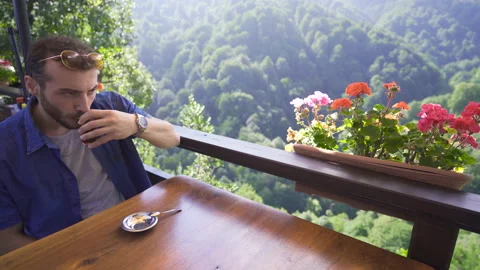 Young man drinking beverage in nature. Stock Footage 212464723