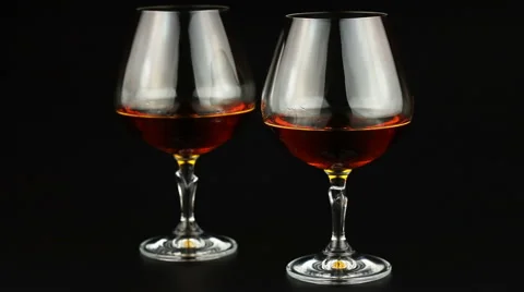 Young man drinking brandy over black background Stock Footage 66242439