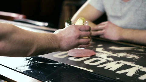 Young man is drinking cocktail while sitting at bar counter. Stock Footage 88576209