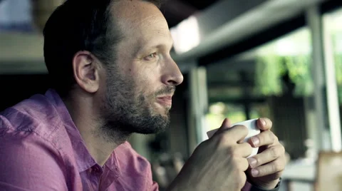 Young man drinking coffee, and eat snack in the restaurant HD Stock Footage 51877205