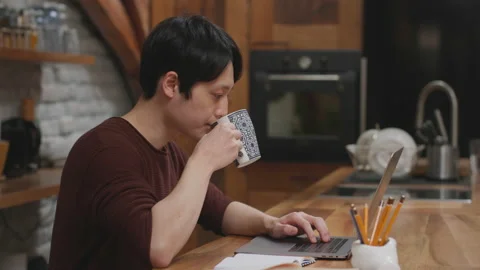 Young man drinking coffee and working. Stock Footage 153497849