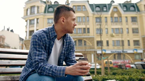 Young man drinking coffee in the city Stock Footage 63180297