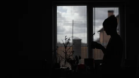 Young man drinking coffee on the corner of the rear light Stock Footage 129341237