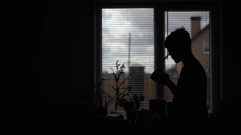 Young man drinking coffee on the corner of the rear light Stock Footage 129341241