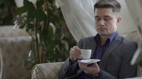 Young man drinking coffee Stock Footage 60951974