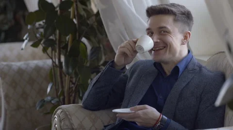 Young man drinking coffee Stock Footage 60952217