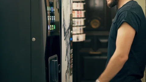 Young Man Drinking Coffee or Tea from Vending Machine Stock Footage 117011985