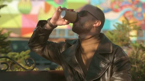 Young man drinking coffee from a paper cup outdoor in cafe Stock-Footage 161084051