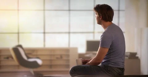 Young man drinking a cup of coffee Stock Footage 78605555