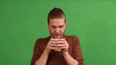 Young man drinking from cup 库存影片 20545643