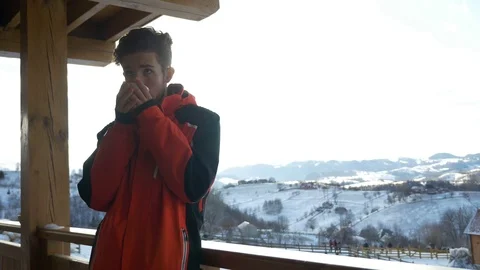 Young man drinking a cup of hot coffee on a deck in winter time Stock Footage 72537522