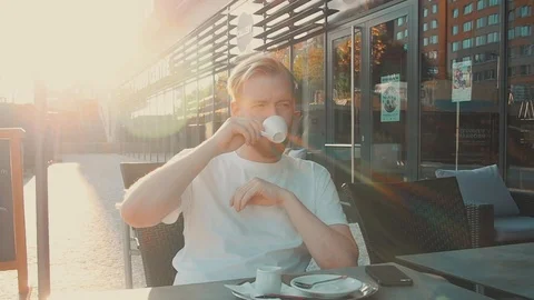 Young Man Drinking Espresso And Texting At Outdoors Cafe Video stock 94973783