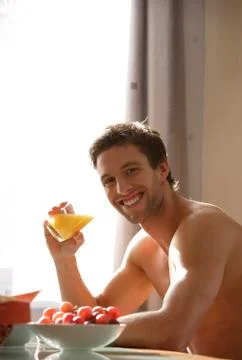 Young man drinking juice Stock Photos