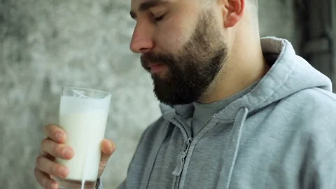 Young man drinking milk Stock Footage 84264744