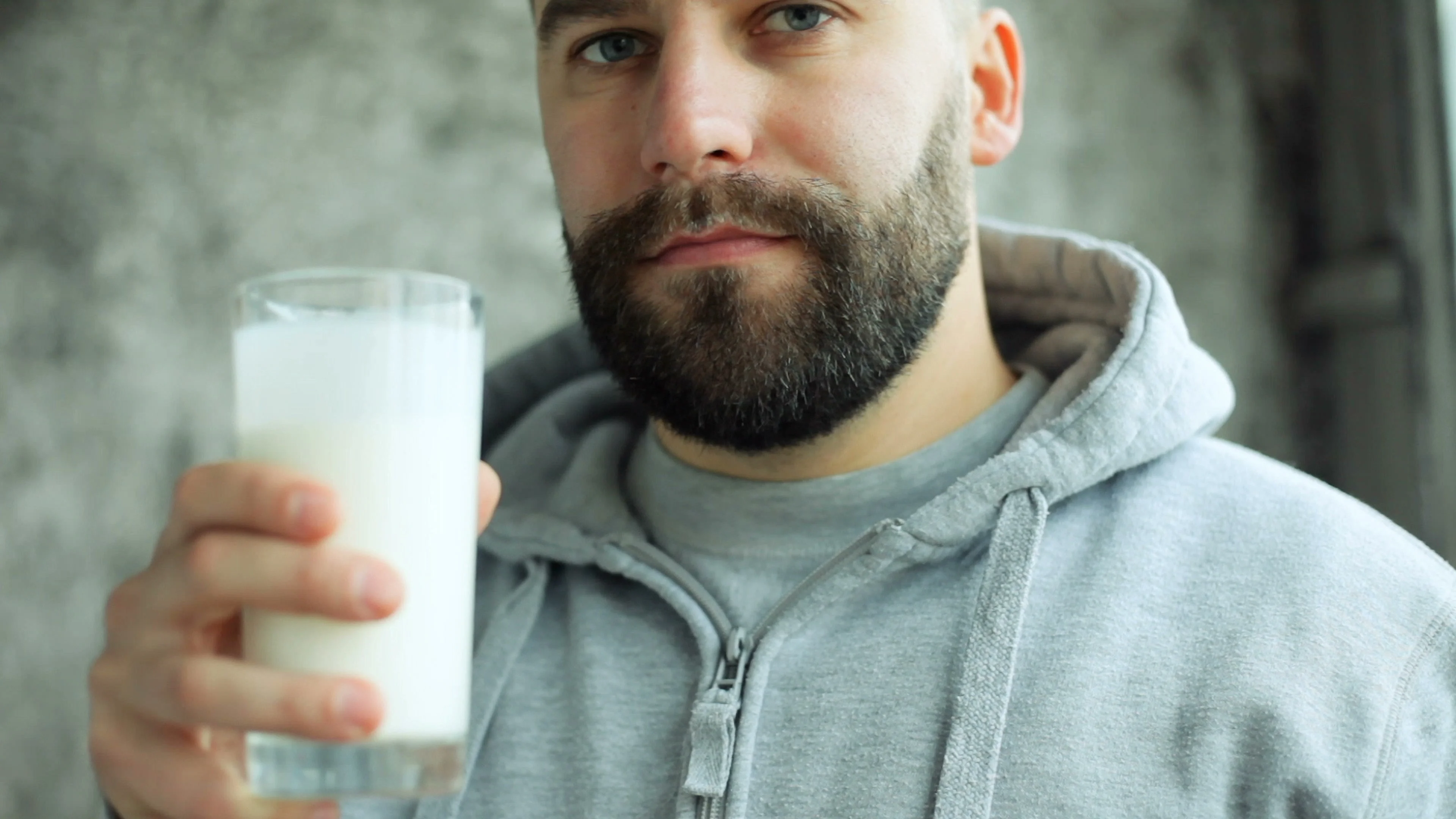 Young man drinking milk | Stock Video | Pond5
