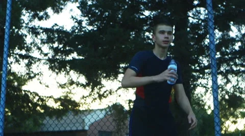 Young man drinking water from a bottle outside Stock Footage 66747495