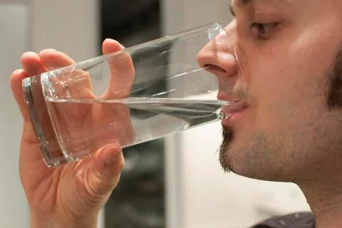 Young man drinking water Stock Photos