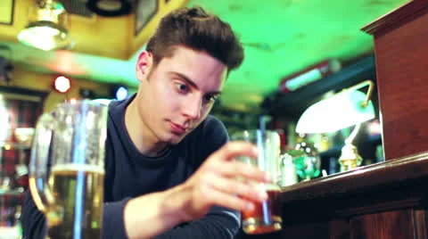 A young man drinks to forget Video stock 22623524