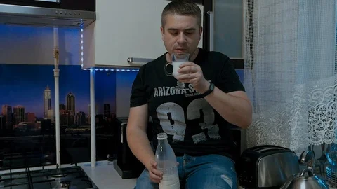 A young man drinks milk! Stock Footage 112077053