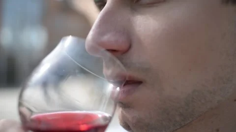 Young Man drinks red wine on the street of an old Europe town Stock Footage 61911932