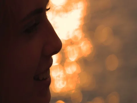 Young man drinks red wine from a glass, sunset by the sea, close-up Video stock 80599292